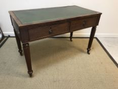 A 19th Century mahogany writing table, the tooled and gilded leather insert top over two frieze