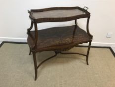 A circa 1900 mahogany and marquetry inlaid étagère with glass based tray within serpentine edging on