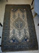 A Caucasian rug, the central panel set with lozenge shaped medallion on a cream ground, with