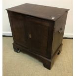 An 18th Century oak dwarf cupboard, the plain top with moulded edge over two panelled doors