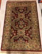 A Chobli rug, the central panel set with foliate decoration on a burgundy gorund, within a stepped