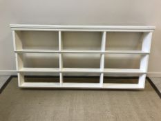 A Victorian white painted three tier set of graduated wall shelves (possibly nursery bookshelves),