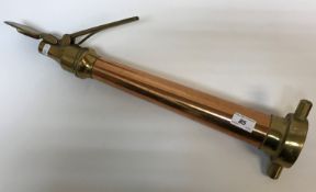 A late 19th / early 20th Century copper and brass fire hose nozzle with fanning implement to the