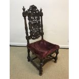 A 19th Century walnut framed hall chair in the Carolean taste, the shell and scroll work carved back