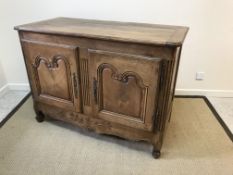 A 19th Century French walnut cupboard in the Louis XV taste, the plank top with cleated ends and