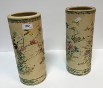 A pair of Meiji Period Japanese Satsuma ware vases of cylindrical form decorated with hooded