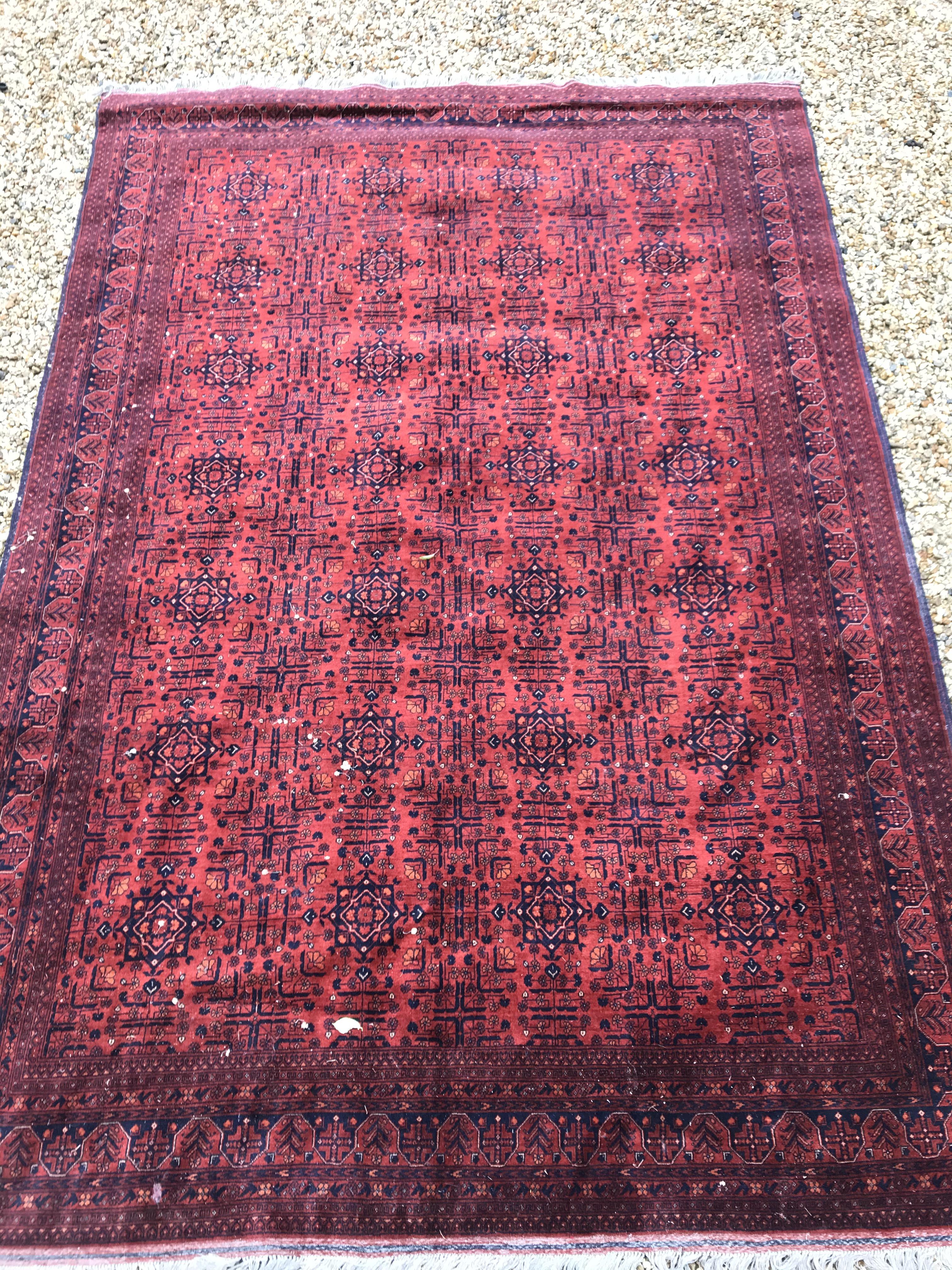 A Bokhara type carpet, the central panel set with repeating medallions on a dark red and black - Image 2 of 23