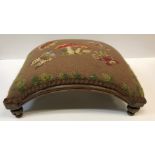 A pair of Victorian needlework upholstered stools, of crescent form, raised on circular feet, one
