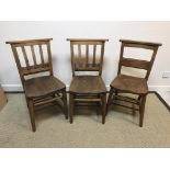 A pair of oak chapel chairs, together with another similar