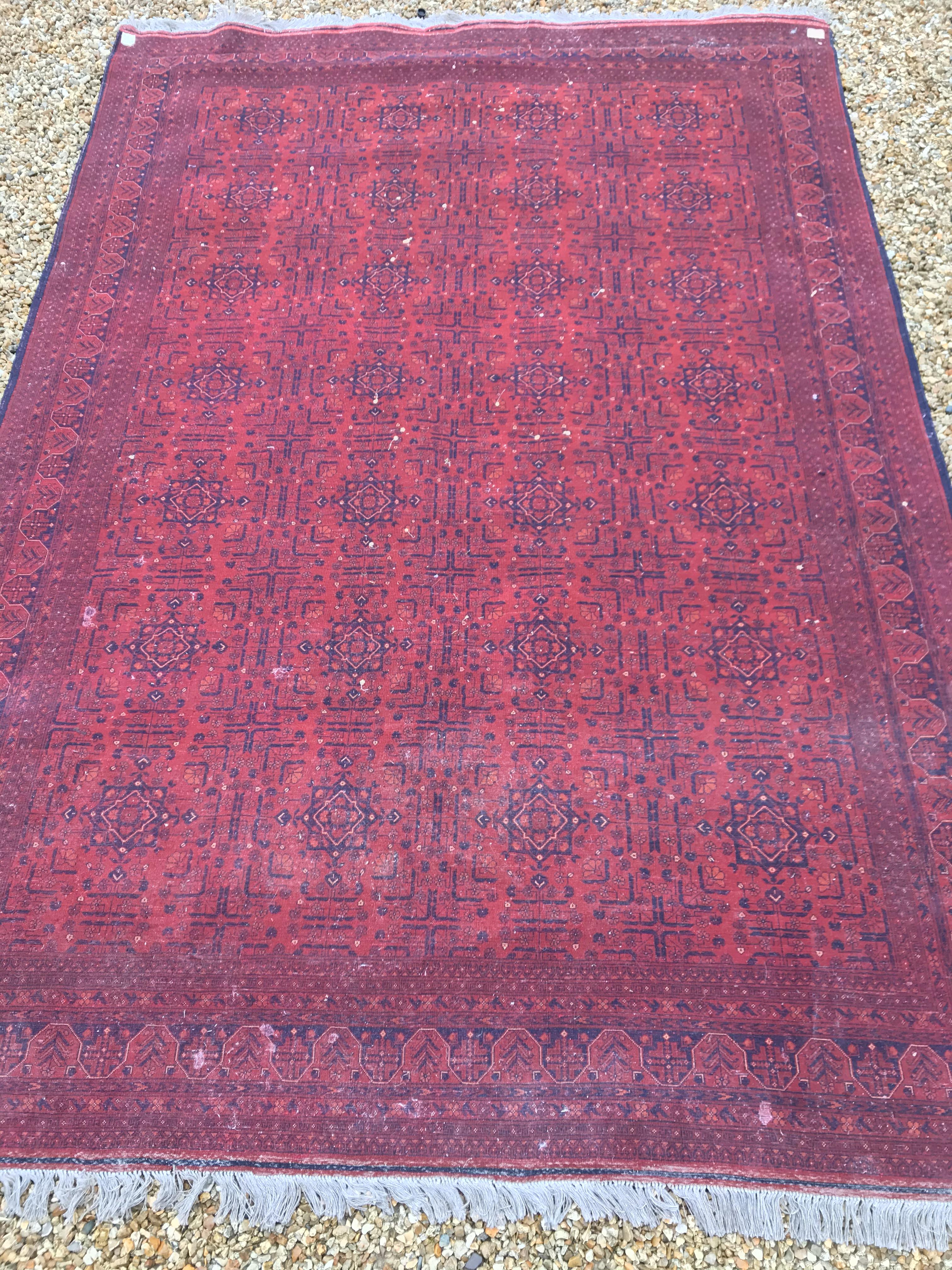 A Bokhara type carpet, the central panel set with repeating medallions on a dark red and black - Image 23 of 23