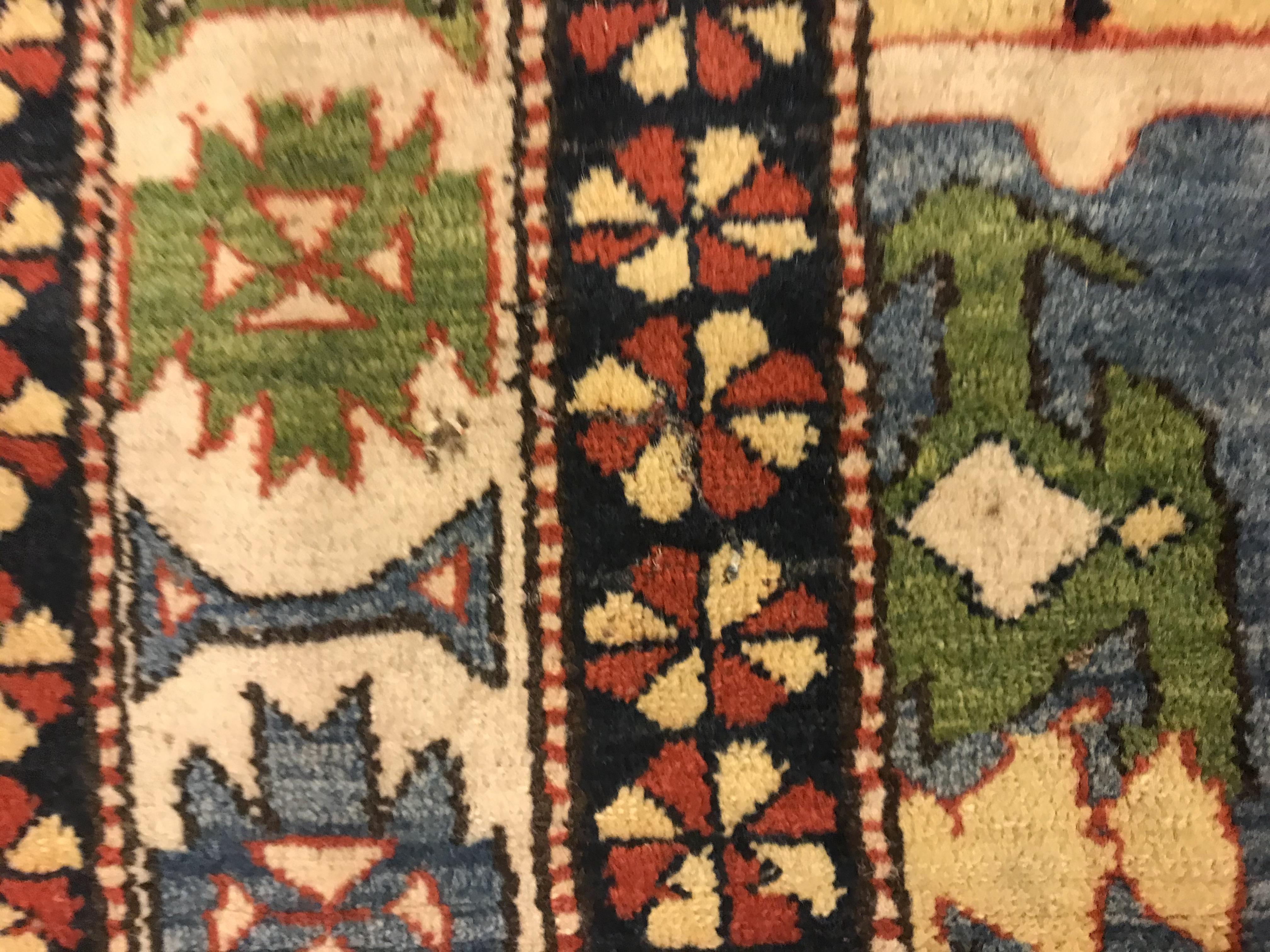 A Caucasian rug, the central panel set with three repeating medallions on a pale blue ground, within - Image 11 of 33