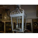 A modern painted metal and glass hall lantern of square tapering form with acanthus leaf style