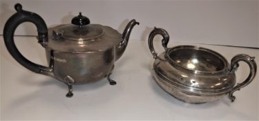 A William IV silver sugar basin of circular form with ribbed centre band and scrollwork handles (