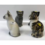 A collection of four medium sized Winstanley pottery glass eyed Cat figures, various colours and
