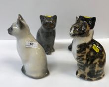 A collection of four medium sized Winstanley pottery glass eyed Cat figures, various colours and