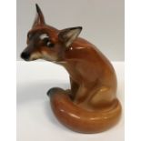 A Royal Doulton figure of a "Seated Fox" (HN130), 22 cm high, together with a Rosenthal Studio Linie