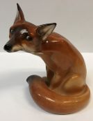 A Royal Doulton figure of a "Seated Fox" (HN130), 22 cm high, together with a Rosenthal Studio Linie