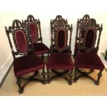 A set of six carved oak Carolean style dining chairs with all-over foliate and floral carved