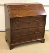 A 19th Century mahogany bureau, the plain top above a sloping fall enclosing a fitted interior