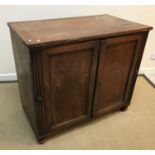 A 19th Century dwarf press cupboard, the plain top above two cupboard doors enclosing two linen