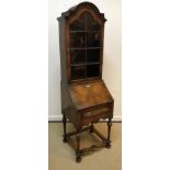 An early 20th Century walnut bureau bookcase in the 18th Century manner, the domed top over a glazed