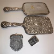 An Edwardian silver two section ring box of coal scuttle form with embossed cherubim decoration (