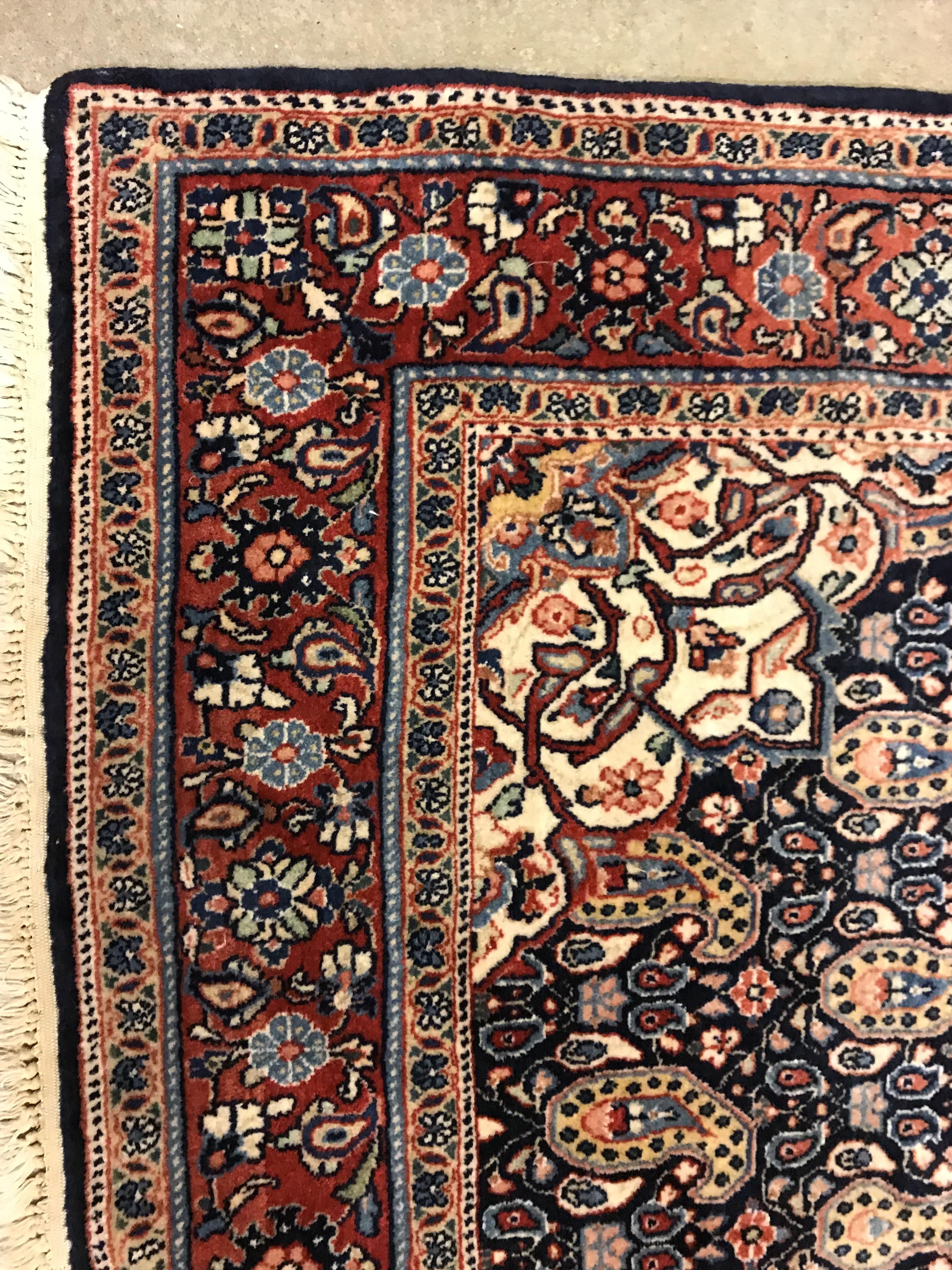 A Kashan carpet, the central panel set with floral decorated medallion on a dark blue hook decorated - Image 3 of 14