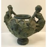 A Continental verdigris patinated plaster two-handled urn decorated with Classical figures and