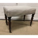 A Victorian grey and white striped upholstered rectangular stool, raised on baluster turned and