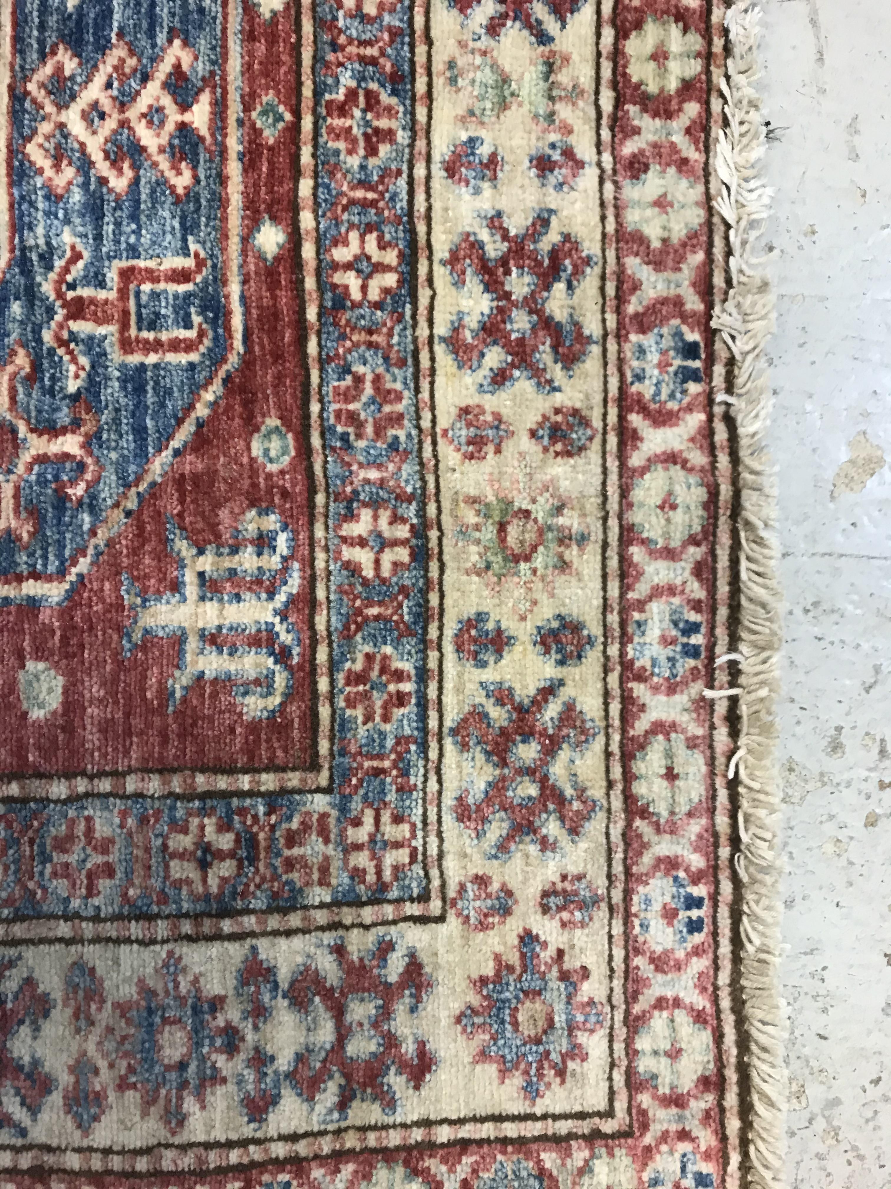 A modern Persian rug, the central panel set with three repeating medallions on a red ground, - Image 5 of 9