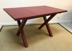 A red leather covered dining table on end "X" trestle supports by Dominic Chambon of Paris, 130 cm