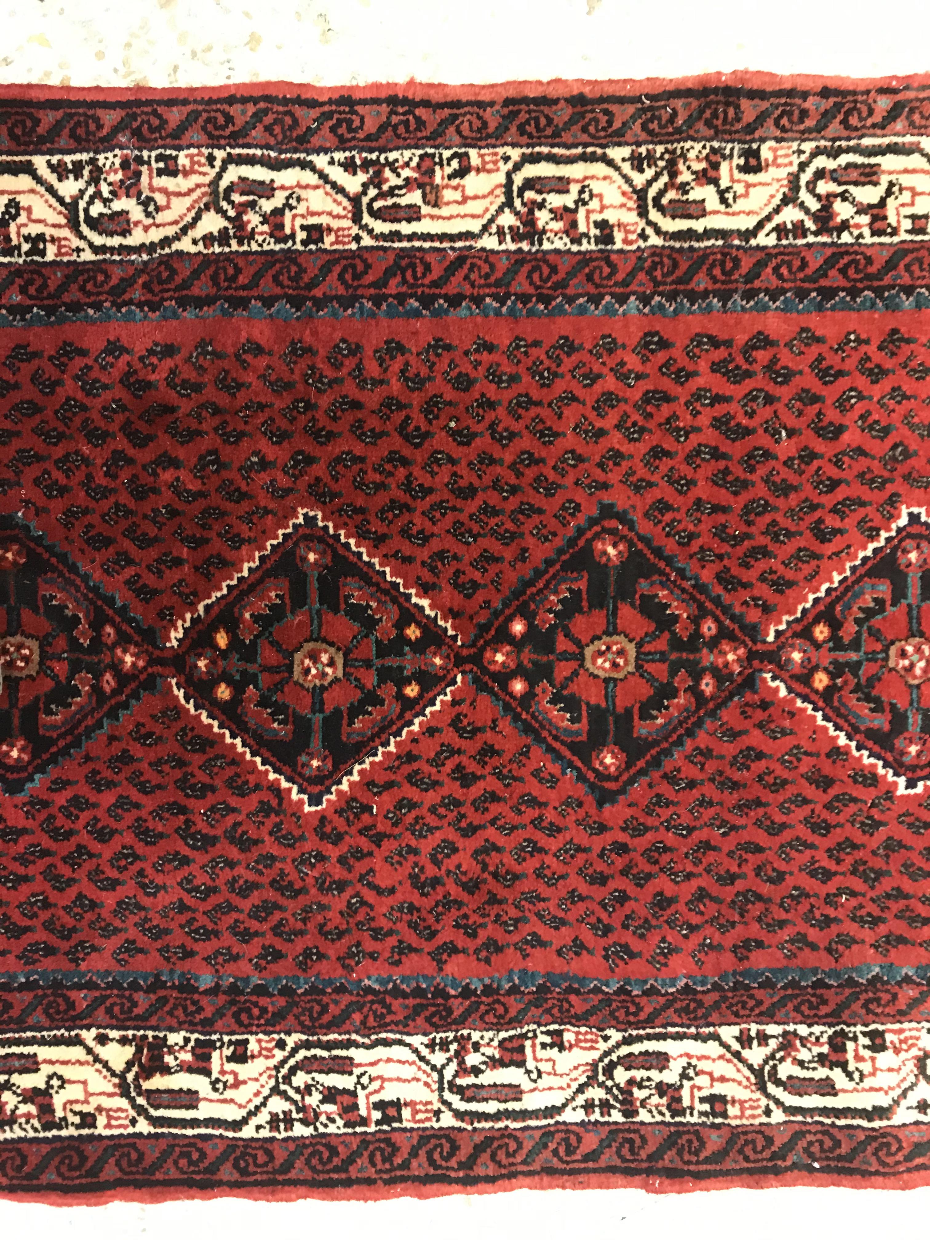 A modern Persian (Iran) runner, the red ground with repeating lozenge medallion with hook style - Image 12 of 23