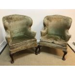 A pair of 18th Century upholstered wing back scroll armchairs with bowed back rail and straight