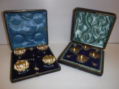 A cased set of four silver open salts and spoons of flower head form, together with spoons (by