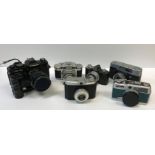 A box containing a collection of nine various cameras, including a Chinon CE-4S, Canon Canonet,