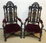 A pair of 19th Century oak and carved throne type chairs in the Carolean taste with upholstered