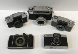 A collection of six various cameras including an Edixa 16-S mini camera, an Olympus Pen-D camera,