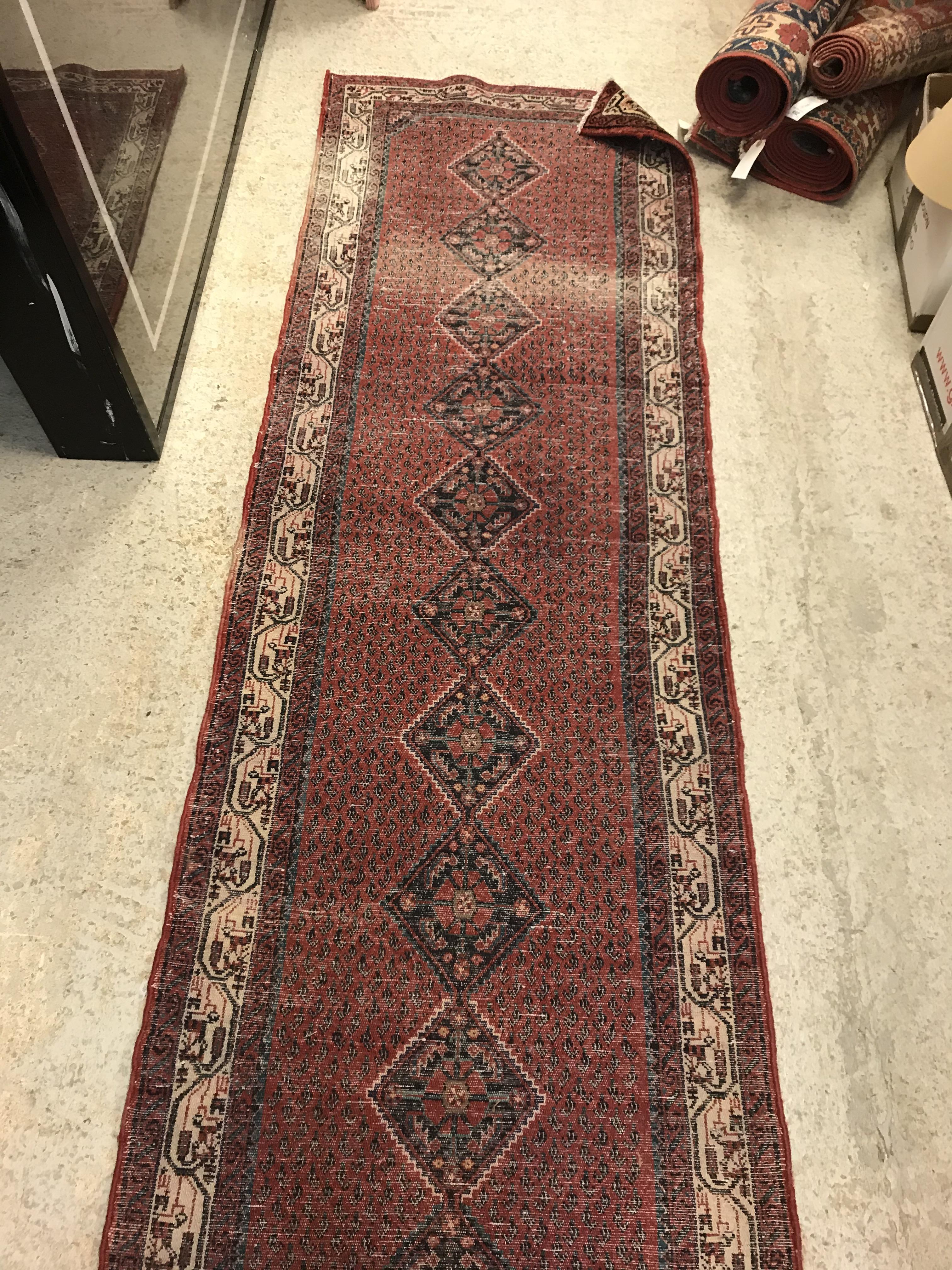 A modern Persian (Iran) runner, the red ground with repeating lozenge medallion with hook style - Image 23 of 23