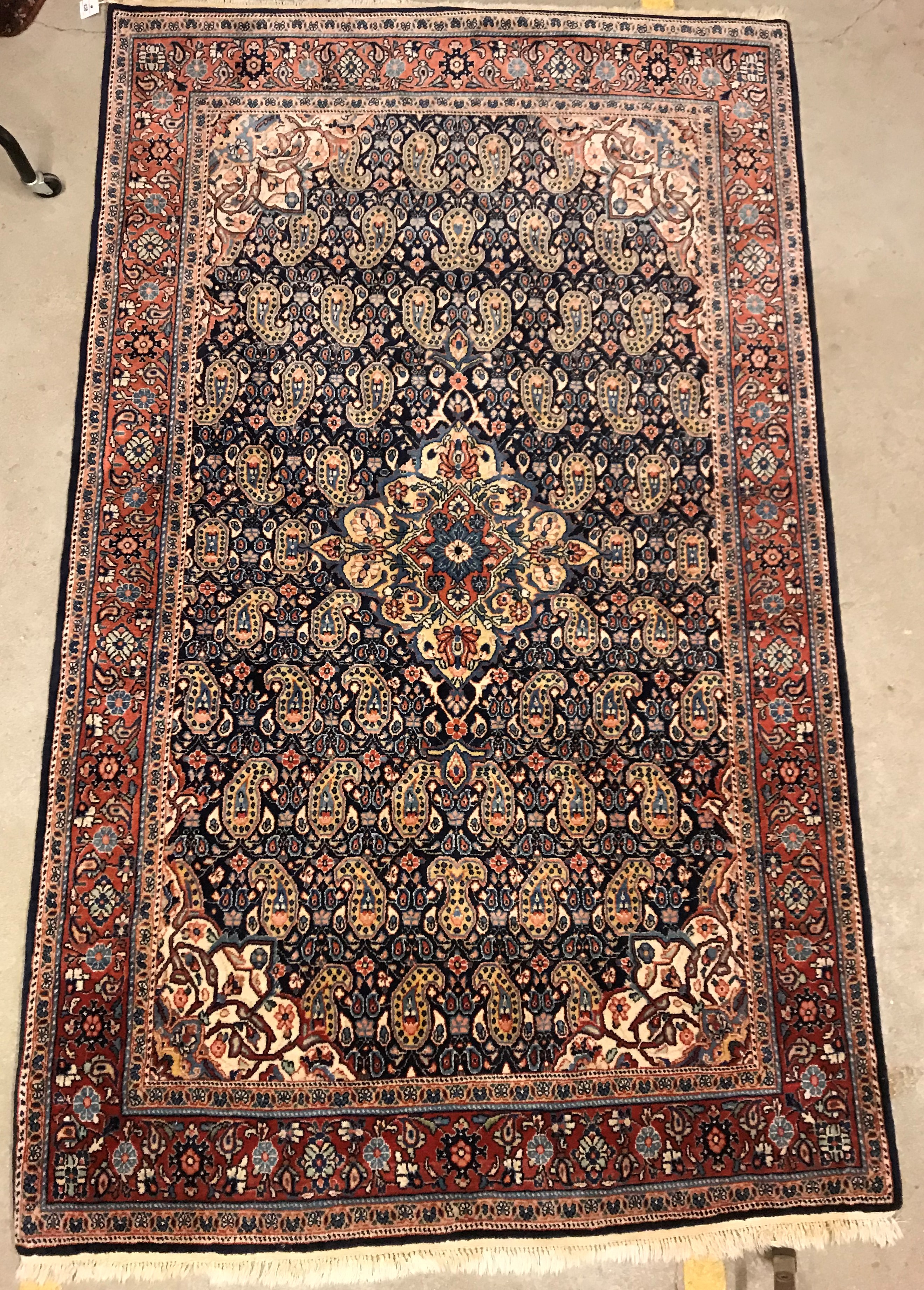 A Kashan carpet, the central panel set with floral decorated medallion on a dark blue hook decorated