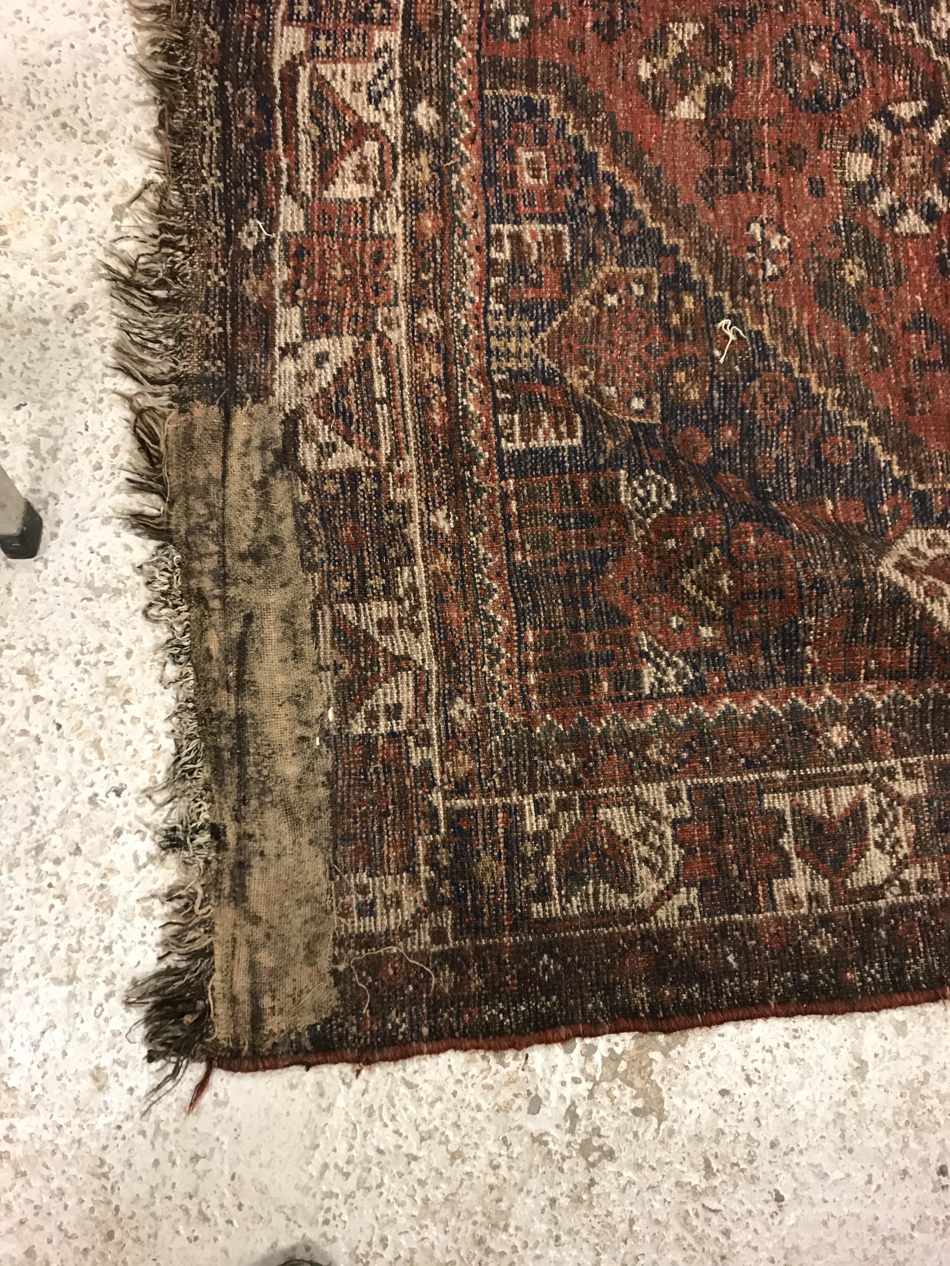 A Shiraz carpet, the central panel set with three joined diamond shaped medallions on a red and blue - Image 16 of 17