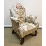 A circa 1900 upholstered scroll arm chair in the 17th Century style, raised on turned cup and