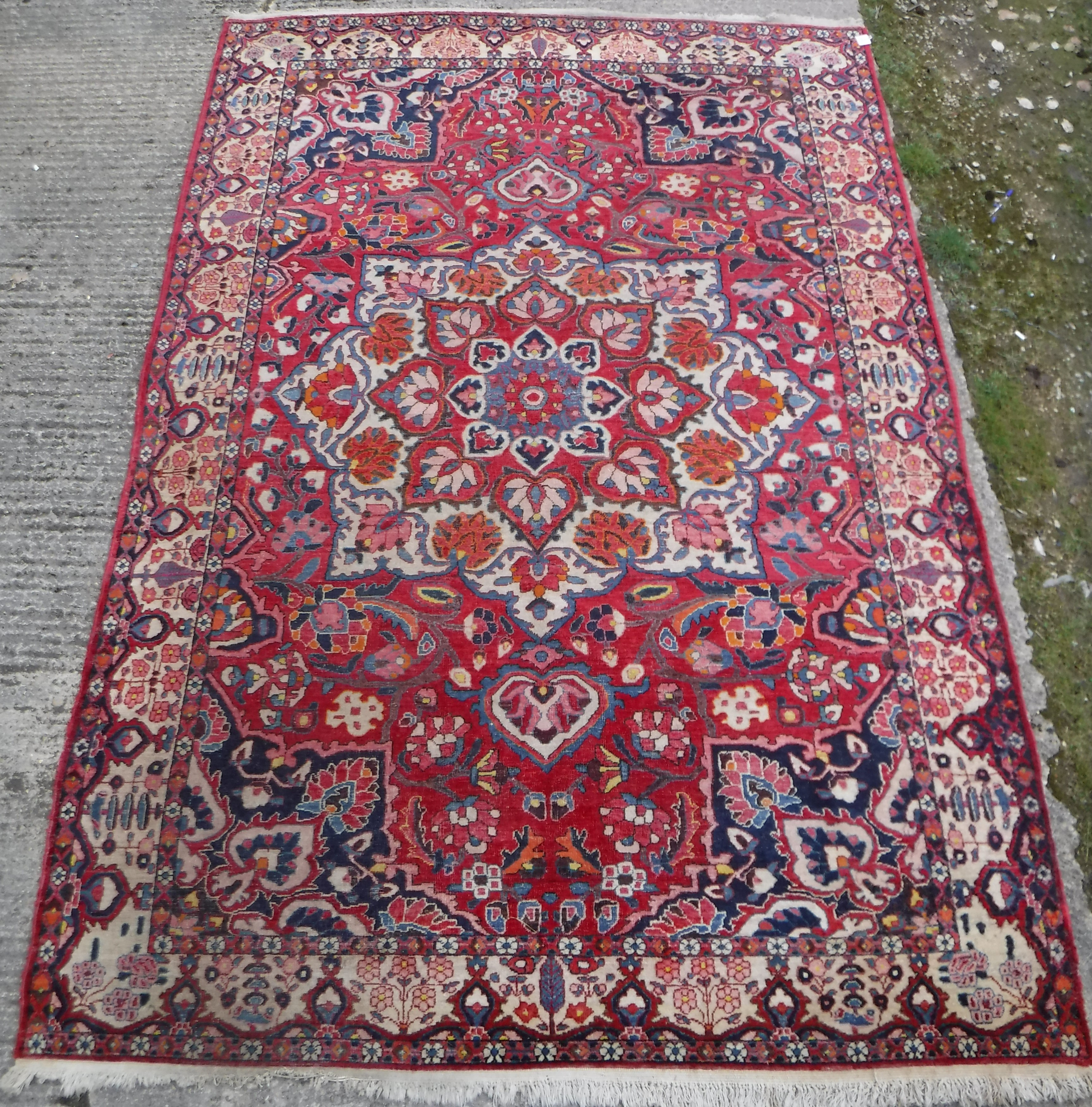 A Caucasian carpet, the central panel set with a flower head medallion on a red ground, with all - Image 9 of 10