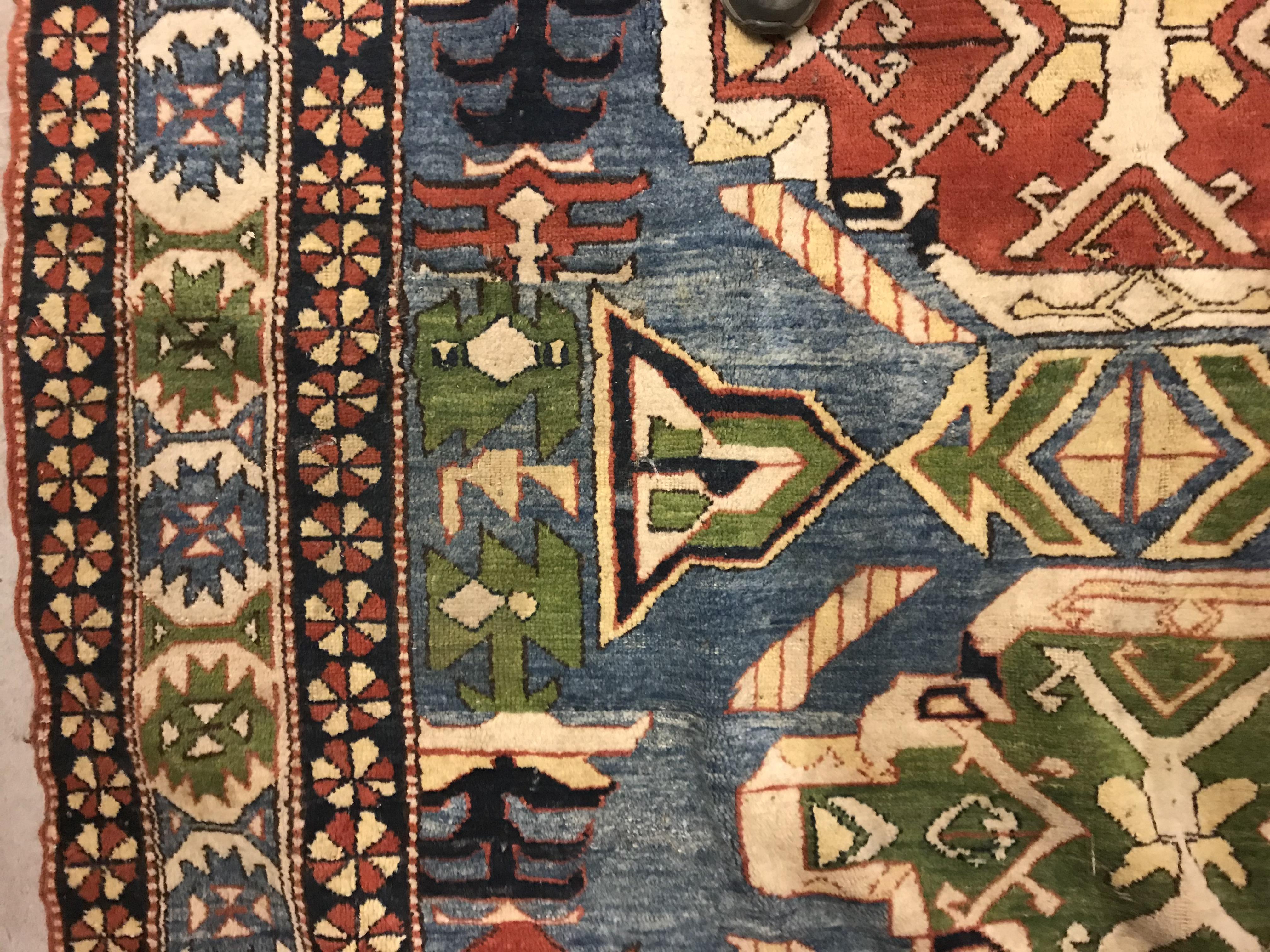 A Caucasian rug, the central panel set with three repeating medallions on a pale blue ground, within - Image 7 of 33