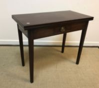 A 19th Century mahogany tea table in the Provincial Chippendale taste, the plain top opening to