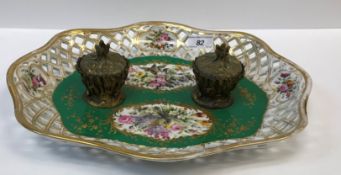 A 19th Century Continental porcelain desk stand, the centre field decorated with panels of birds