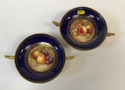 A pair of Royal Worcester circular two-handled pedestal dishes, blue and gilt decorated, the