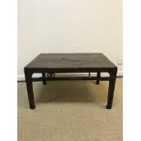 A Chinese elm occasional table of rectangular form, the plain top above a linked medallion decorated