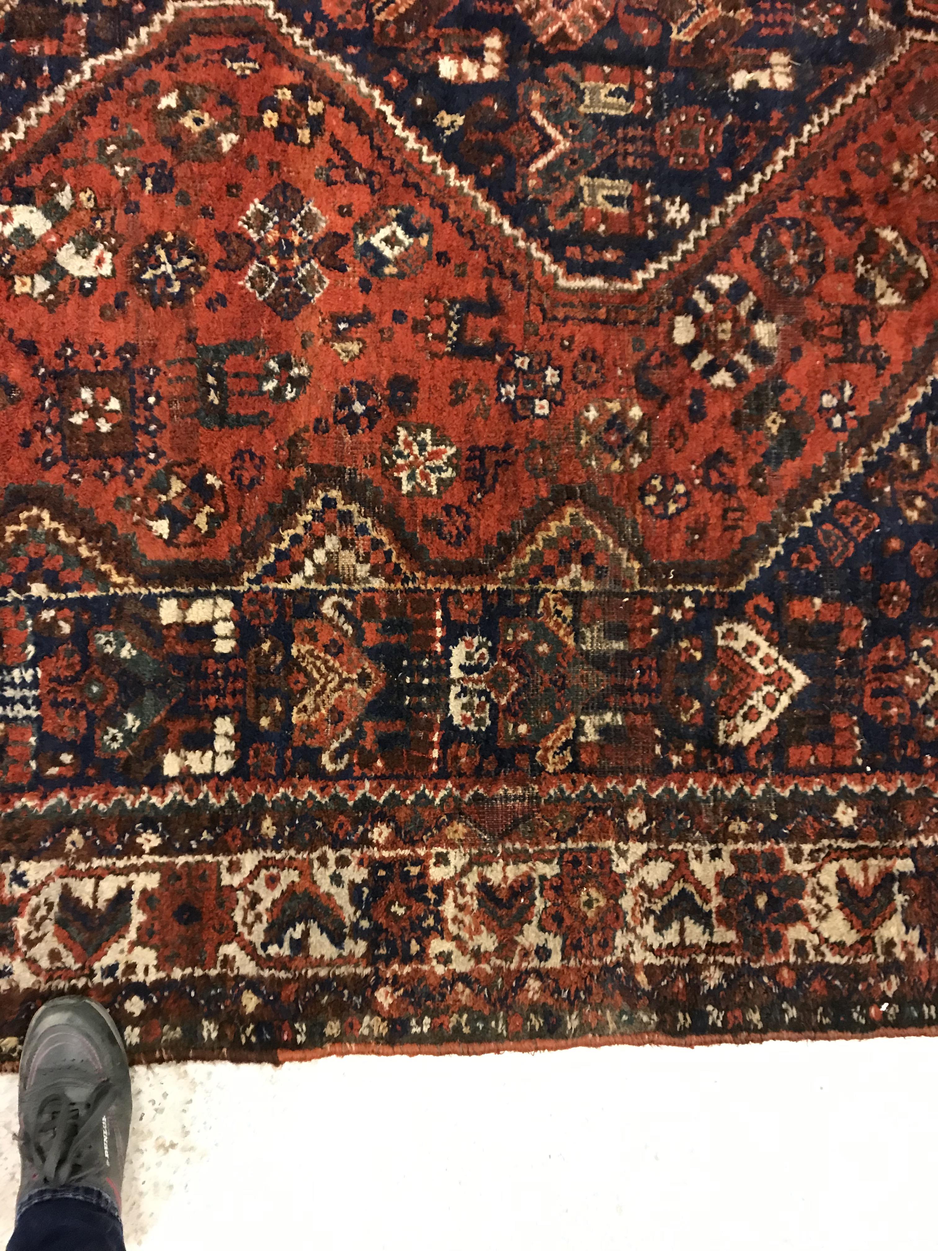 A Shiraz carpet, the central panel set with three joined diamond shaped medallions on a red and blue - Image 5 of 17