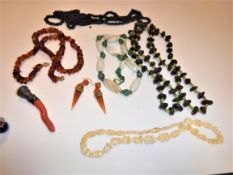 A 20th Century amber bead necklace, 55 cm long, a pair of amber coloured conical drop earrings