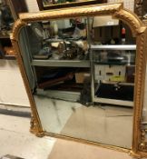 A late Victorian giltwood and gesso framed overmantel mirror with scrolling ribbon and beaded edge